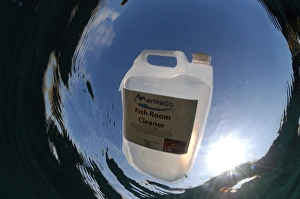 Drifting Prints: Fish Room Cleaner plastic container floating in sea