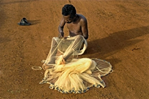 Nets Prints: Fisherman mending nets on beach, Trivandrum, Kerala, India