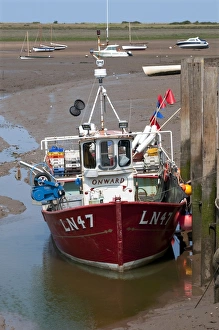 Industry Prints: Fishing boat moored at jetty in coastal creek at low tide