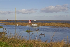 Flooded coast road and marshes after tidal surge, Cley-next-the-sea, North Norfolk, England, December 2013