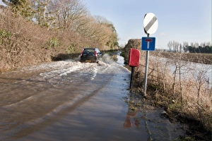 Cars Prints: Flooded rural road with vehicle driving through, West Sussex, England, january