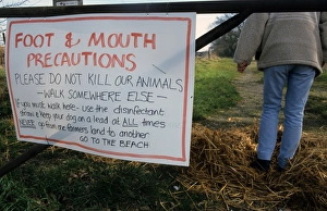 Prevent Prints: Foot and Mouth Precautions sign on farm gate, with walker using disinfected straw