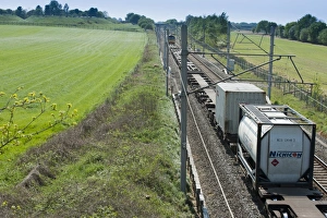 Transports Prints: Frieght train travelling through farmland, Goostrey, Cheshire, England, april