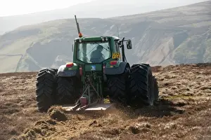Burning Prints: Gamekeeper on shooting estate cutting fire break patch in heather moorland
