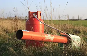 Gas-gun, gas powered bird scarer at edge of arable field, Bacton, Suffolk, England, march