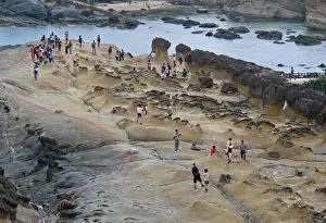 Site Prints: Ginger Rock formation on eroded coastal rocks with tourists