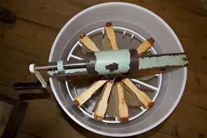 The honey comb frames are placed into a spinning drum and then spun at high speed to separate the honey from the comb