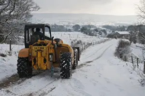 Loaders Prints: JCB 530 loader clearing snow from road for milk tanker on dairy farm
