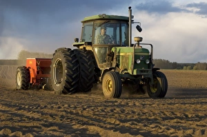 Drill Prints: John Deere 2140 tractor pulling Tume seed drill, drilling arable field, Sweden