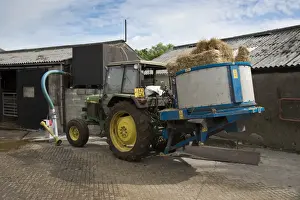 Machinery Prints: John Deere 2450 tractor with straw bedding machine on dairy farm