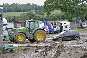 Cars Prints: John Deere 6930 tractor pulling car out of muddy carpark at agricultural show