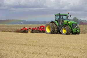 John Deere 7720 tractor with Vaderstad 560 flexible cultivator, cultivating stubble field, Sweden, august