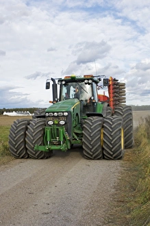Track Prints: John Deere 8530 tractor, with dual wheels, driving along rural track, Sweden