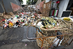 Environmental Prints: Large pile of rubbish and collection baskets in city