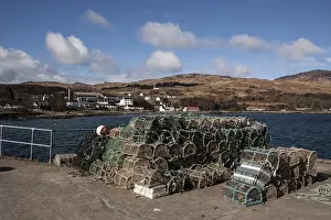 Pots Prints: Lobster pots on Jura Pier with Jura Hotel and whiskey distillery behind