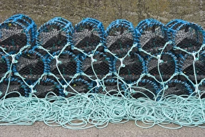 Lobster pots on quayside of harbour, Burnmouth, Scottish Borders, Scotland, july