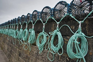 Lobster pots on quayside of harbour, Burnmouth, Scottish Borders, Scotland, july
