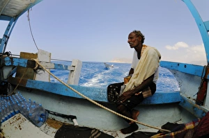 Local Prints: Local fisherman sitting on boat at sea, Socotra, Yemen, march