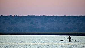 Canoe Prints: Makoro canoe silhouetted at sunset, Chobe N. P. Botswana, July