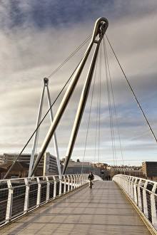 Cycling Prints: Man on bicycle crossing footbridge over river