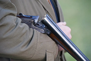 Gamebird Prints: Man holding loaded 12 bore shotgun