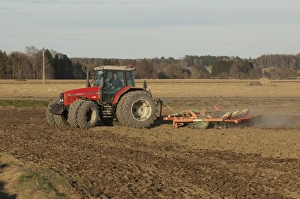 Massey Fergusson 6290 tractor with harrows, harrowing field seedbed, Sweden, may