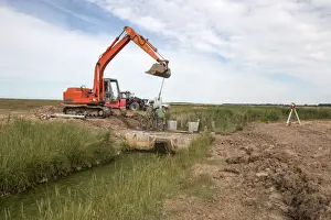 Metal pilings being fitting to make a sluice gate to retain water at Deepdale Marsh, Burnham Deepdale, North Norfolk