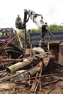 Lorries Prints: Metal recycler collecting assorted scrap metal with mechanical grabber on farm