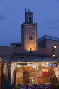 Moroccan Prints: Mosque minaret and market stand in city at dusk, Djemaa el Fna, Marrakesh, Morocco, april