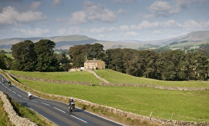 : Motorcyclists on rural road speeding and doing wheelie