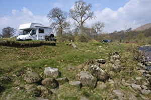 Cars Prints: Motorhome and cars parked near riverbank