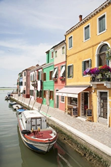 Colourful Prints: Multi-coloured houses and shops along canal waterfront