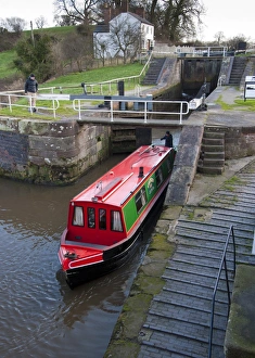 Gates Prints: Narrowboat moving through canal staircase lock