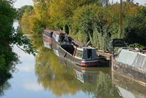 Water Ways Prints: Narrowboats moored at boatyard on canal