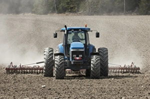 Prepare Prints: New Holland 8770 tractor with harrows, harrowing field seedbed, Sweden, may