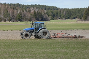 Prepare Prints: New Holland TM165 tractor with harrows, harrowing field seedbed, Sweden, may
