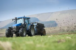 Spreading Prints: New Holland TS115 tractor with muckspreader