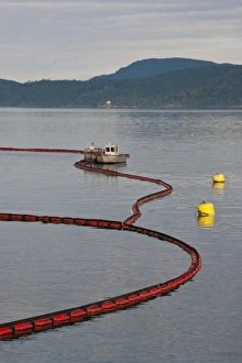 Pollution Prints: Oil boom on sea around oil refinery