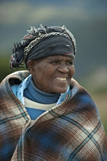 Woman Prints: Old woman smiling, wrapped in blanket