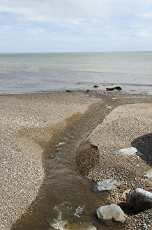 Tide Prints: Outlet of the River Sid onto the shingle beach of Sidmouth in Devon