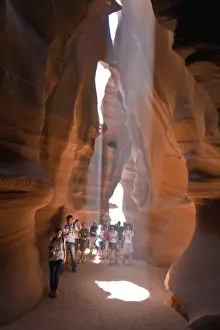 Erosion Prints: People caught in Light beam in Upper Antelope Canyon was formed by erosion of Navajo Sandstone