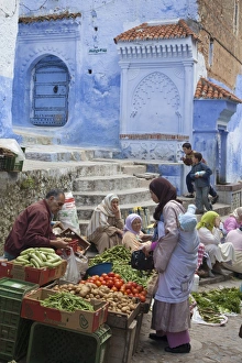 Colors Prints: People at market beside blue houses in city, Chefchaouen, Morocco, april