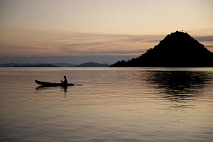 Canoe Prints: Person rowing kayak from island at sunset, Kelor Island, near Flores Island, Komodo N. P