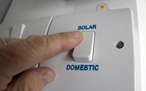 Renewable Prints: Person turning on solar power switch, England