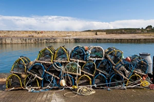 Industry Prints: Pile of lobster pots stacked on quayside, Hopeman Harbour, Morayshire, Scotland, March