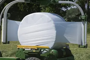 Wrapped Prints: Plastic wrapping round silage bale with mechanical bale-wrapper, Sweden