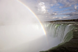 Rainbow forming in spray over waterfall, Horseshoe Falls, Niagara Falls, Niagara River, Ontario, Canada, august