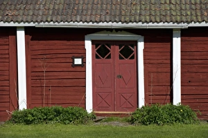 Walls Prints: Red door and wooden walls of old house