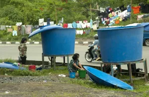 Supply Prints: Refugees from recent volcanic eruption washing clothes beside big vats of water