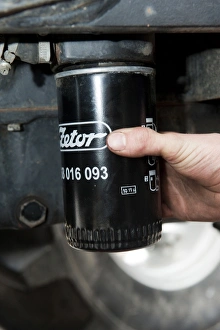 Removed Prints: Removing oil filter from tractor engine block, England, october